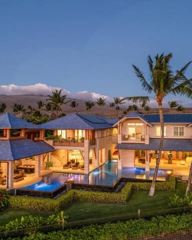 Oceanfront lanai with lounge chair, palm trees, and Pacific views
